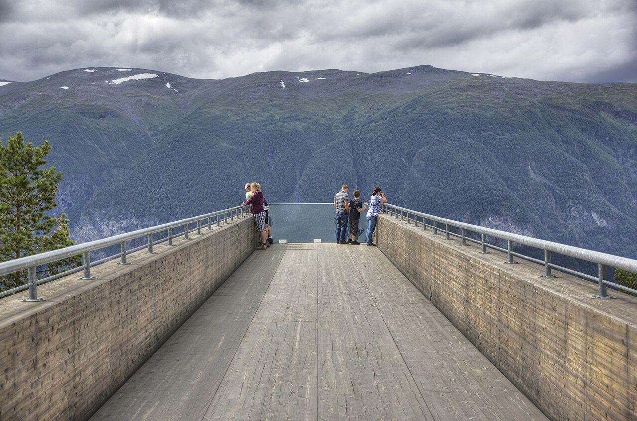 The Stegastein viewing platform reaching out over the fjord, with visitors at the railing
